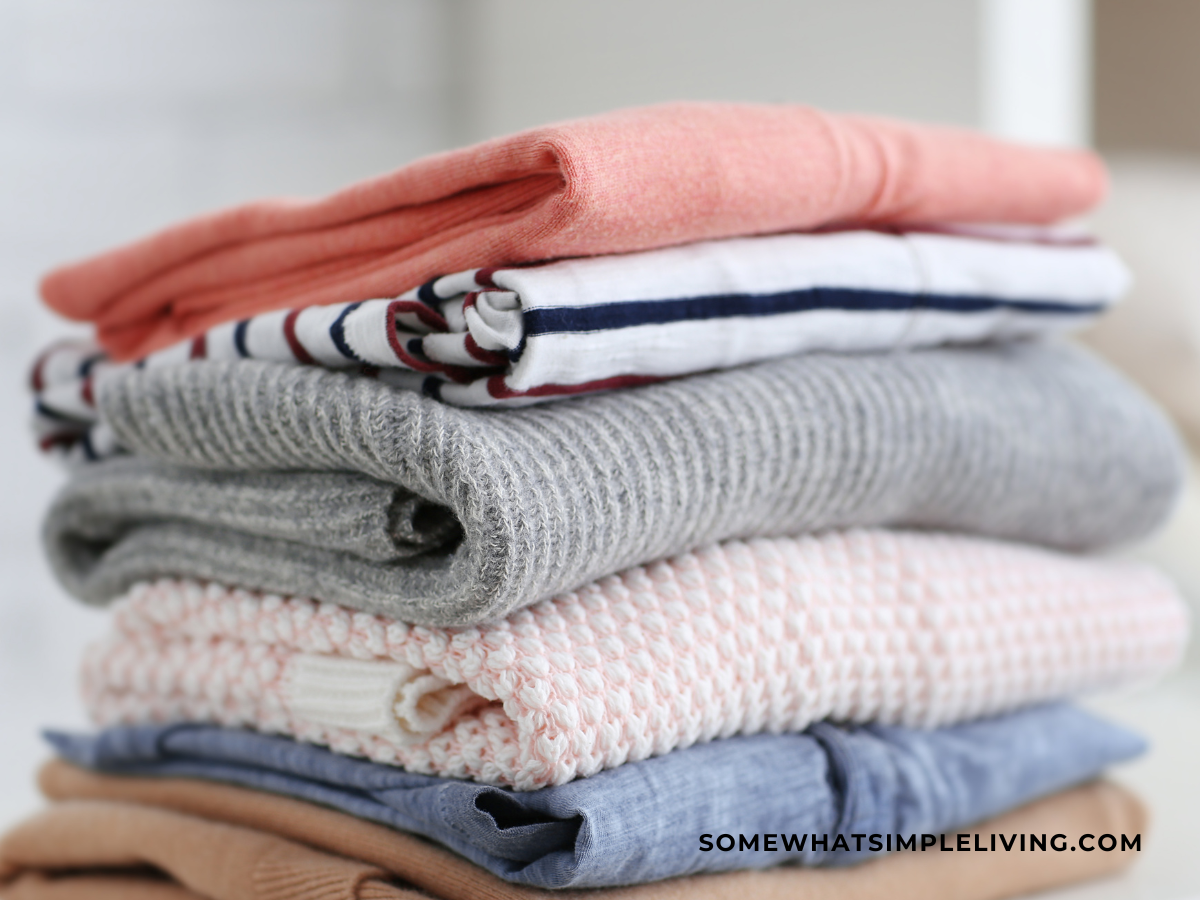 neatly folded pile of shirts and sweaters