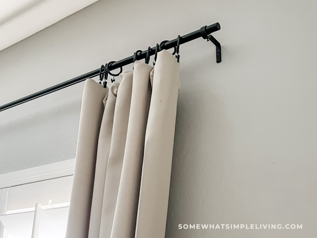 how to hang a curtain rod high and wide from the window treatment