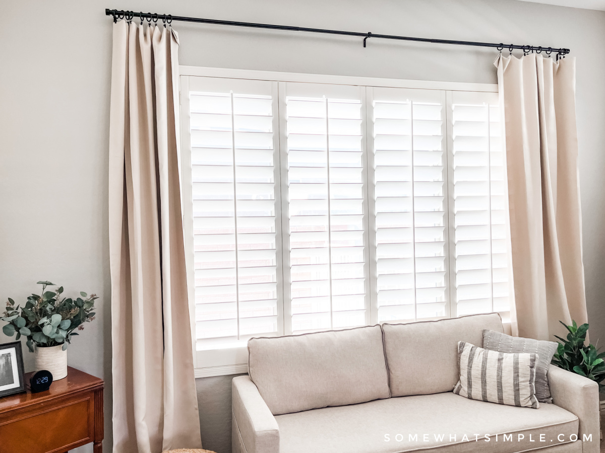 curtains and a couch in a primary bedroom