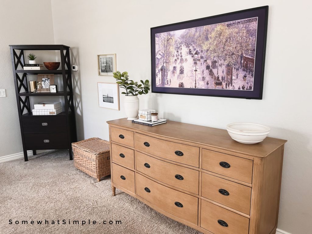 light wood dresser with frame tv over it