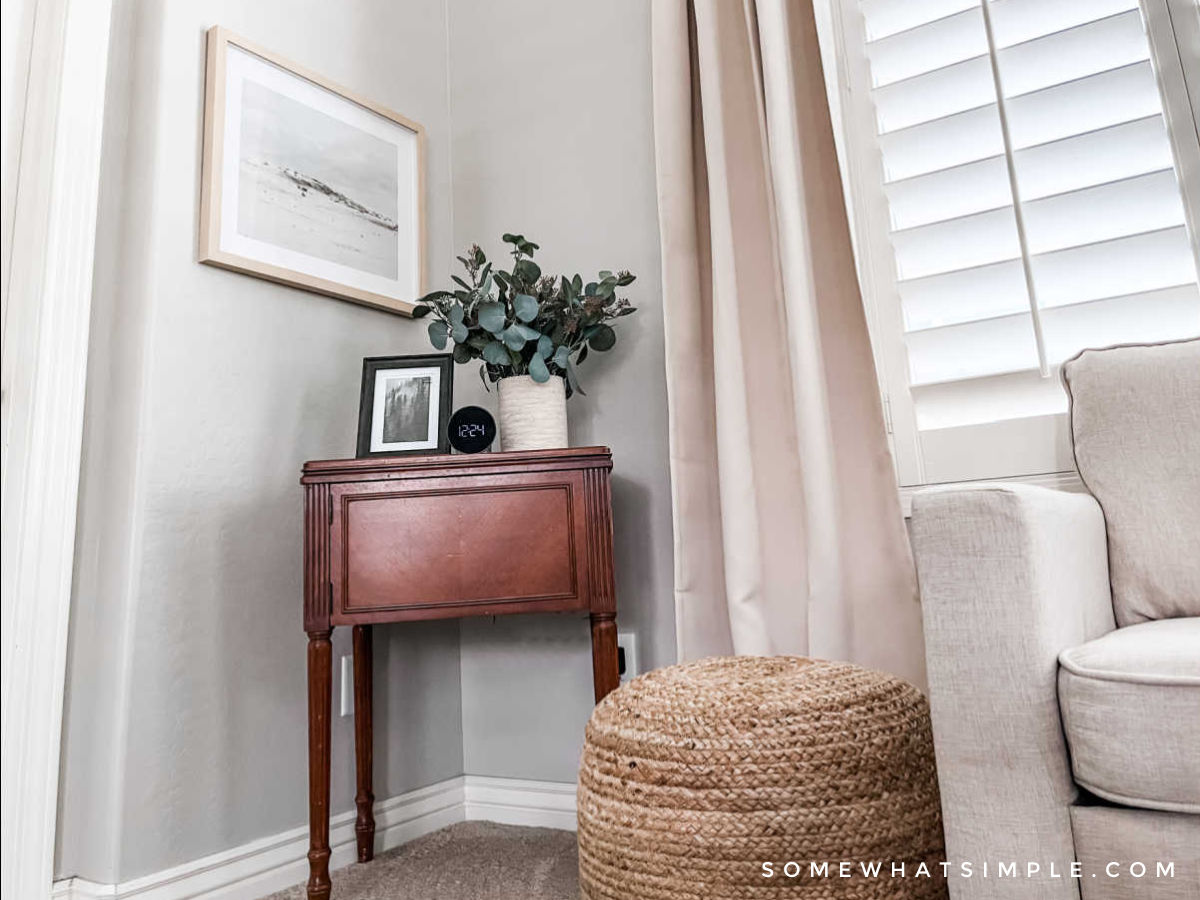 antique sewing table in the corner of a primary bedroom