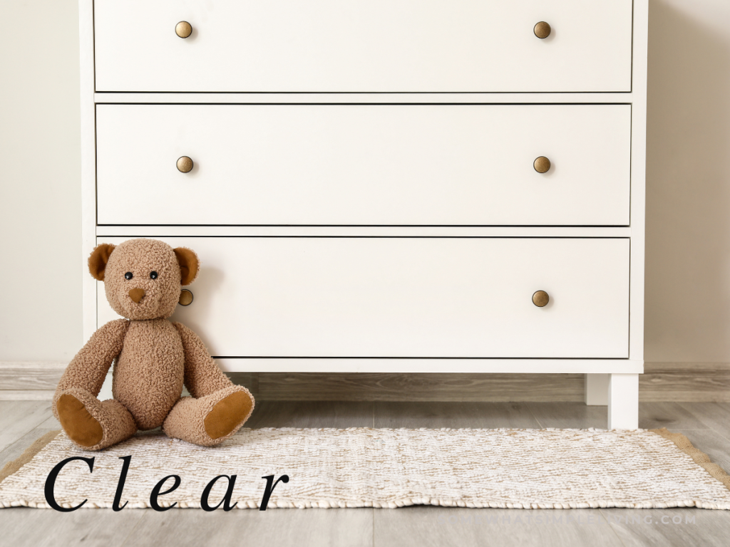 White dresser with teddy bear sitting in front