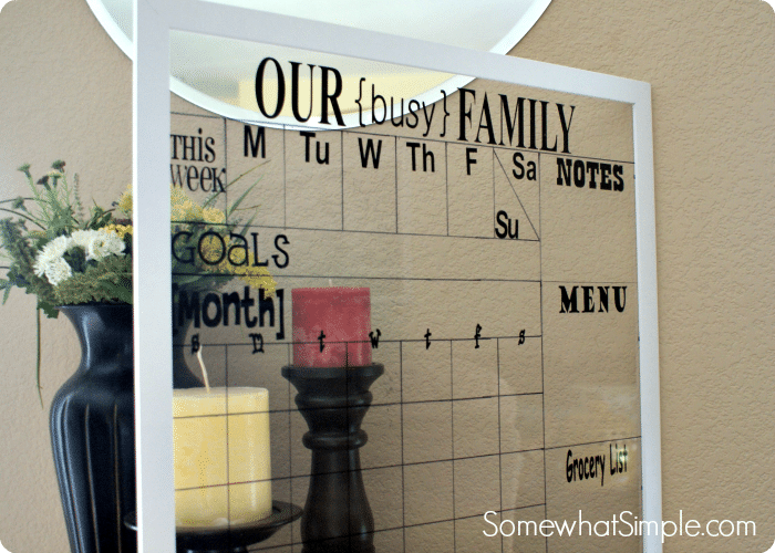 framed glass with black sticker on it making it into a family calendar