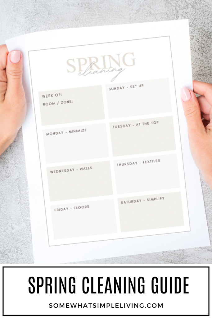 long image of womans hands holding a spring cleaning schedule