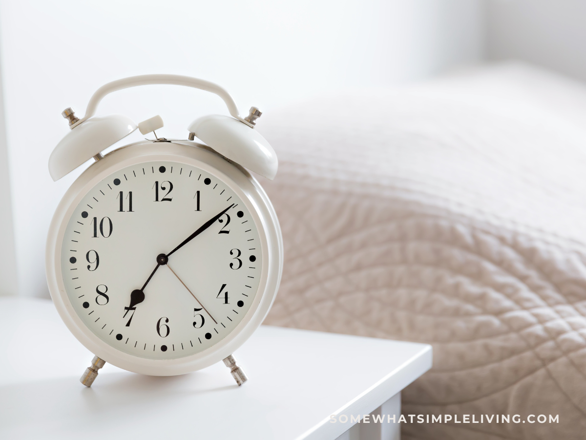 alarm clock next to a bed