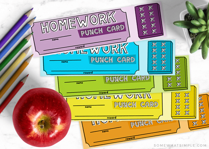looking down on a purple, blue, green, yellow and orange homework punch card that can also be used as a bookmark