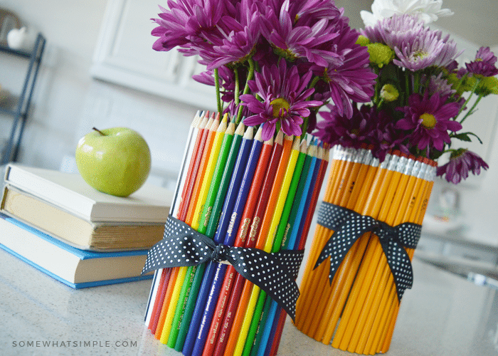 two flower vases wrapped in pencils