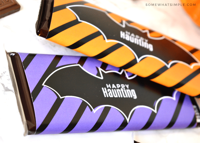 a close up of candy bars with a bat wrapper around them that says happy haunting