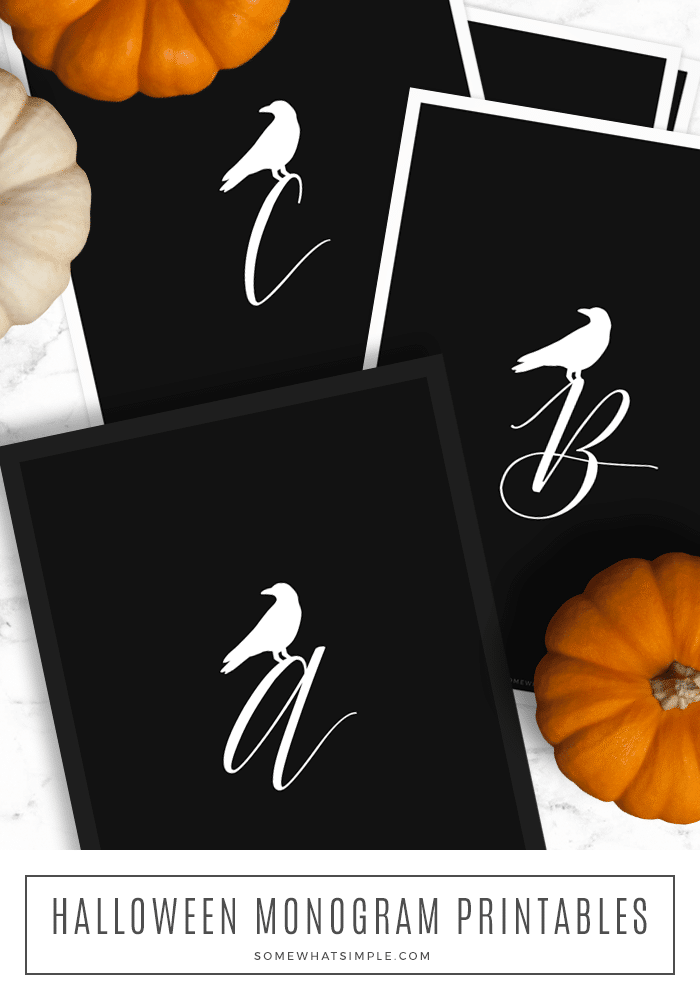looking down on black sheets of paper with a crow monogram