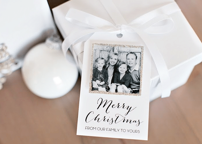 White christmas card with gold frame on a white gift box