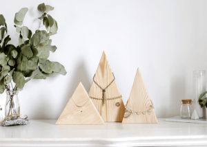 3 wooden triangles holding jewelry