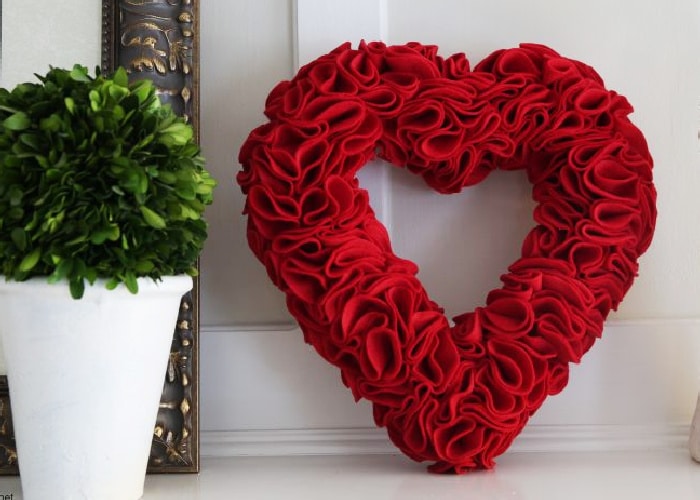 red felt wreath in the shape of a heart