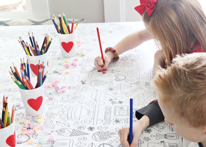 kids coloring on a tablecloth for Valentines Day