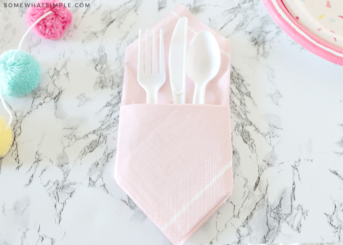 pink napkin with white plasticware