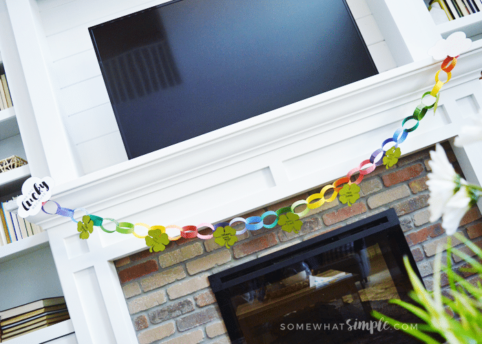 a colorful paper garland hanging from a mantle 