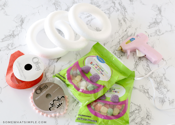 ribbon, wreath forms, hot glue and gumdrops on a counter