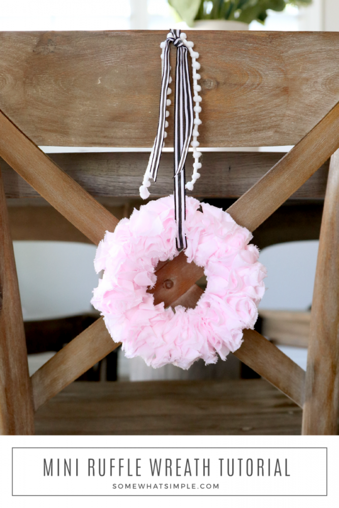 mini pink ruffle wreath handing on the back of a chair