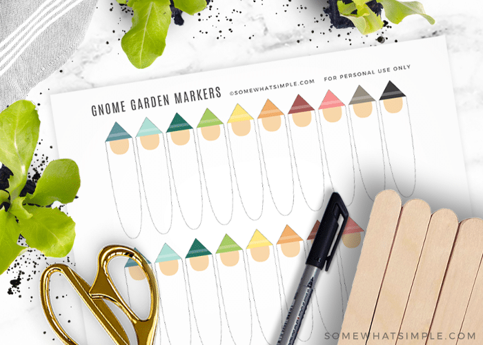 printable gnome plant markers next to craft sticks, scissors, and a black sharpie marker