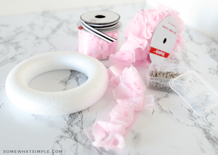 materials needed to make a wreath - form, ribbon laying on the counter