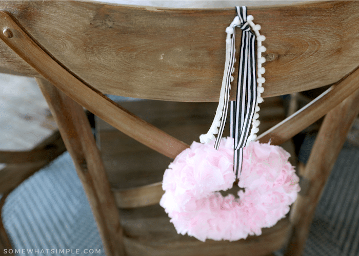 mini wreath hanging on the back of a chair