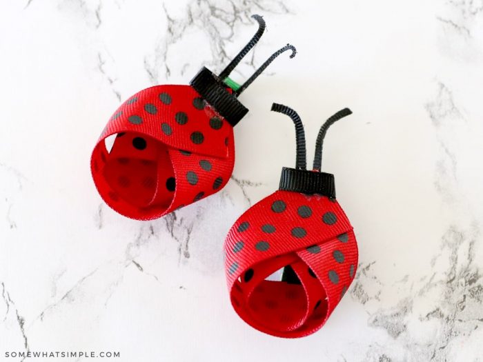 2 ladybug bows on a white counter