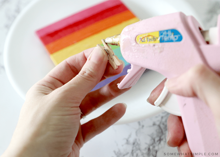 adding hot glue to a clothes pin