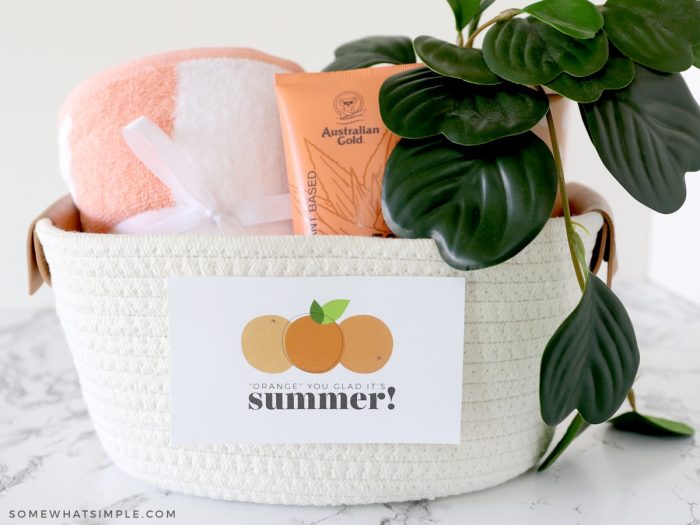basket with orange sunscreen and towel 