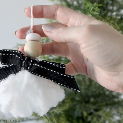 holding an angel ornament made from a tampon