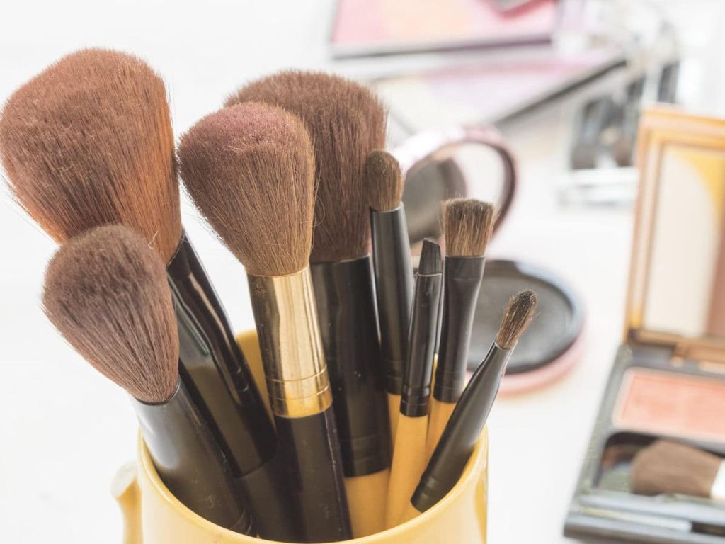 clean makeup brushes in a mug