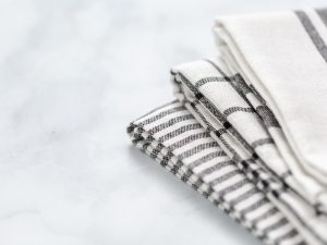stack of kitchen towels on a white counter