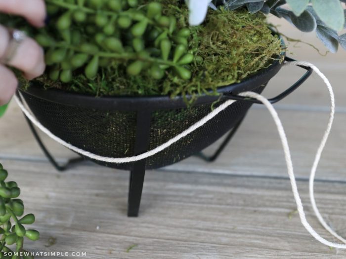 weaving twine around a colander planter