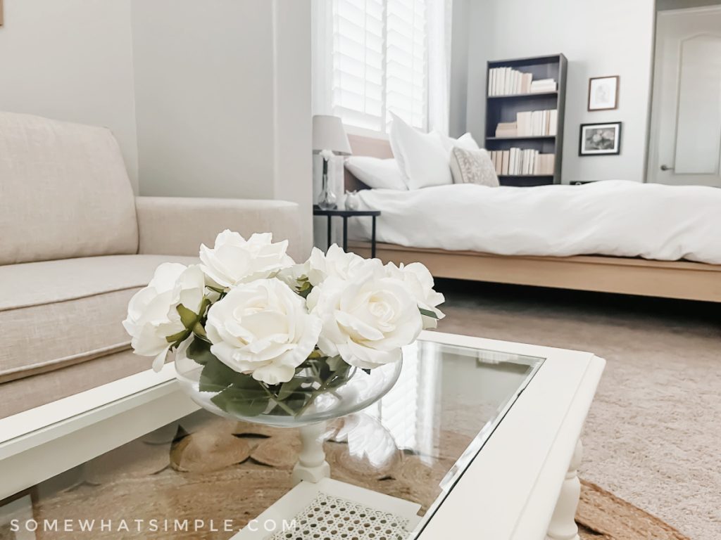 close up of roses in a vase on a coffee table