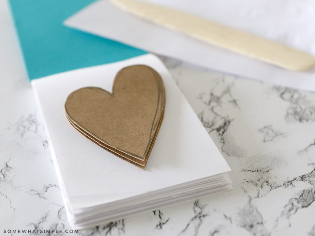 stack of cardboard hearts on a notepad
