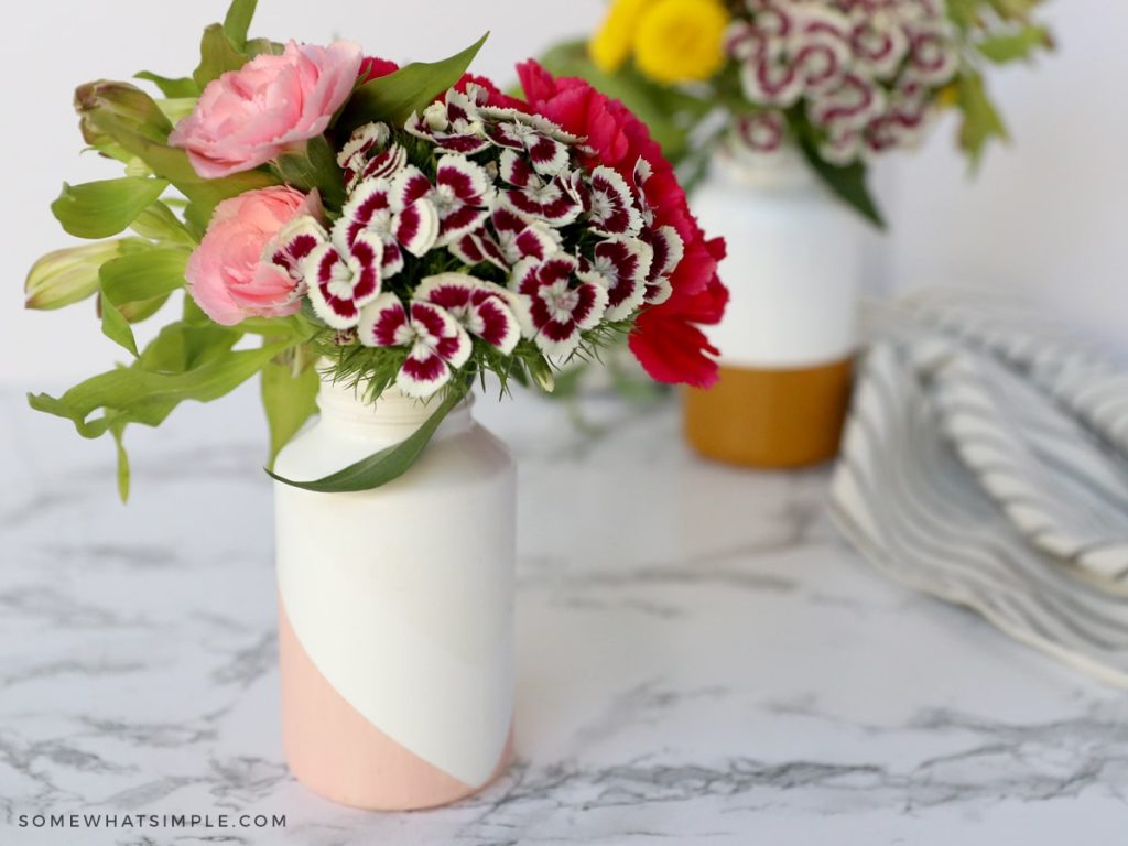 two recycled medicine bottles made into a flower vase