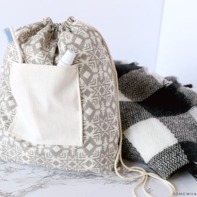 tote backpack next to a black and white blanket