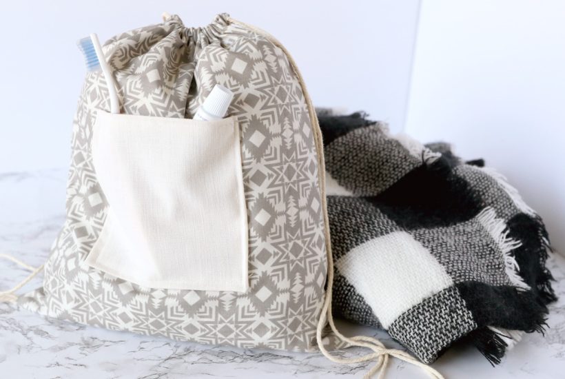 tote backpack next to a black and white blanket