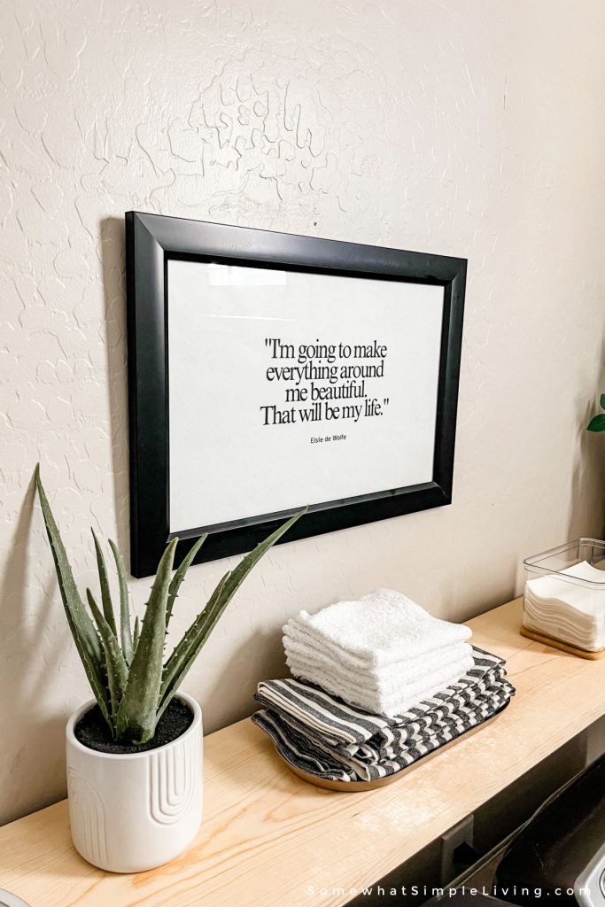 framed printable quote in a laundry room