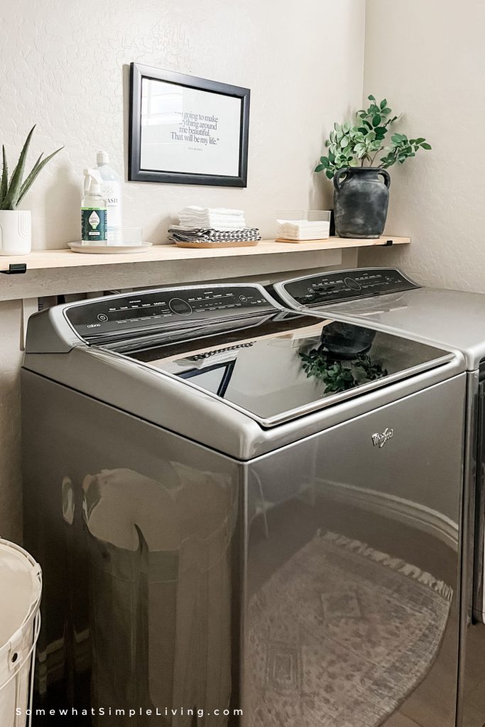 view of a washing machine with a shelf over the top that has been styled
