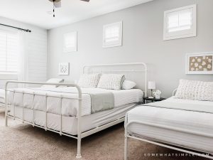fresh and clean guest room with 3 beds