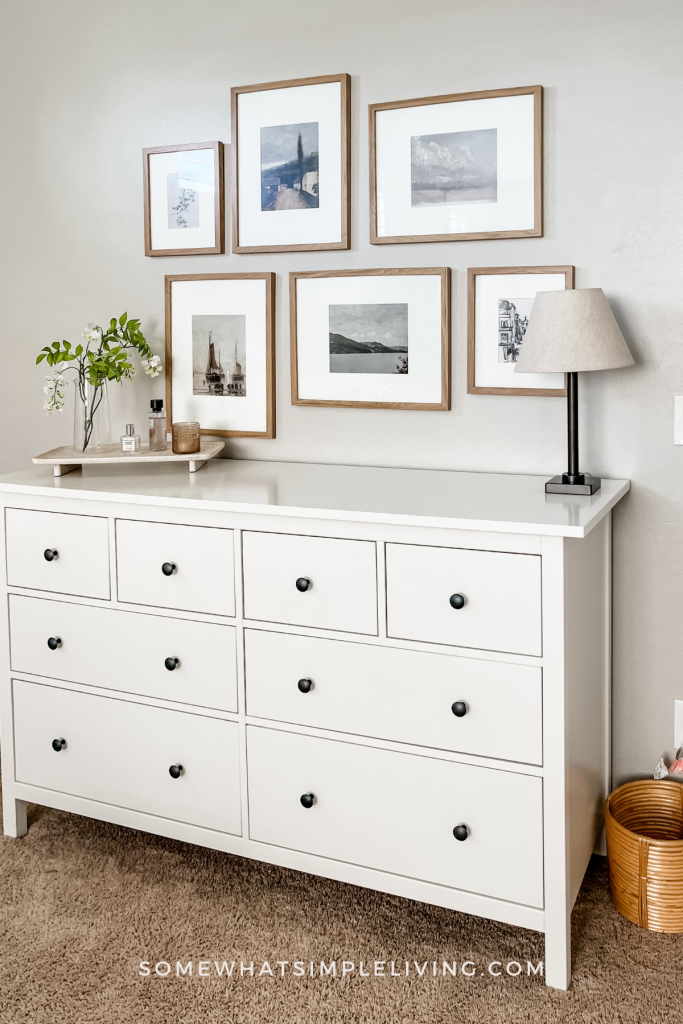 white dresser with framed artwork above it