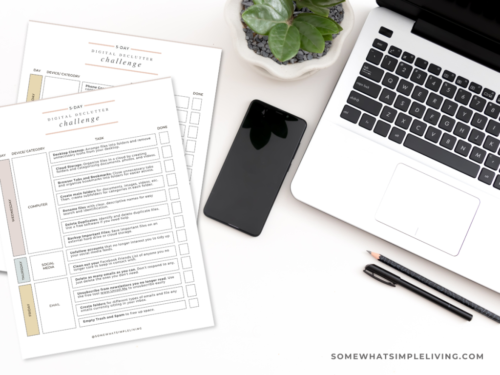 computer and phone next to a paper checklist for a digital declutter challenge