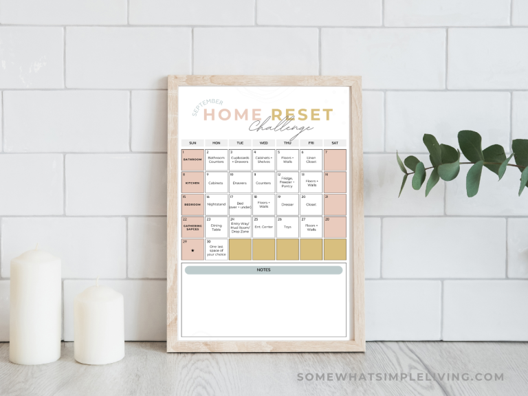 framed challenge calendar on a counter with candles and a plant