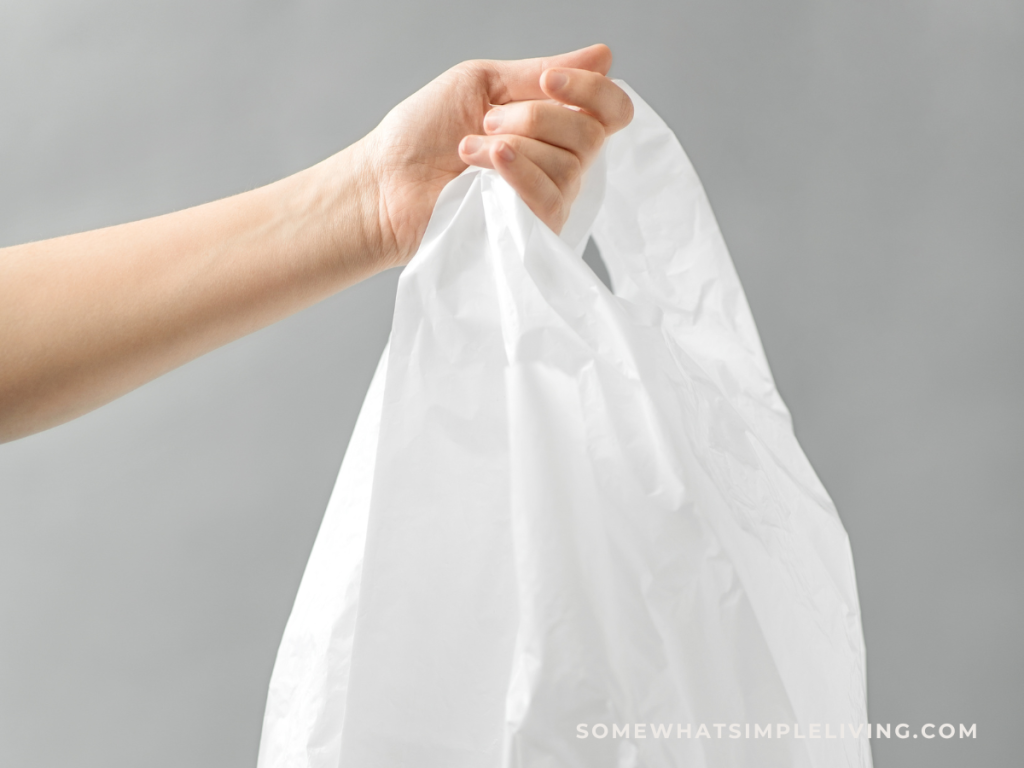 woman holding a plastic trash bag in her hand