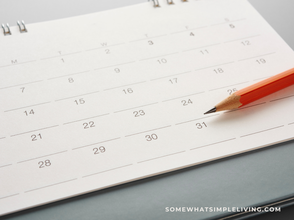 close up of a calendar with a pencil laying on top of it