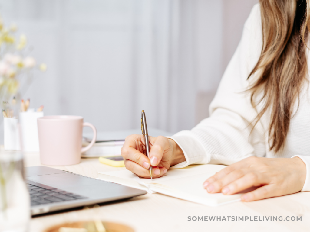 woman writing at her desk