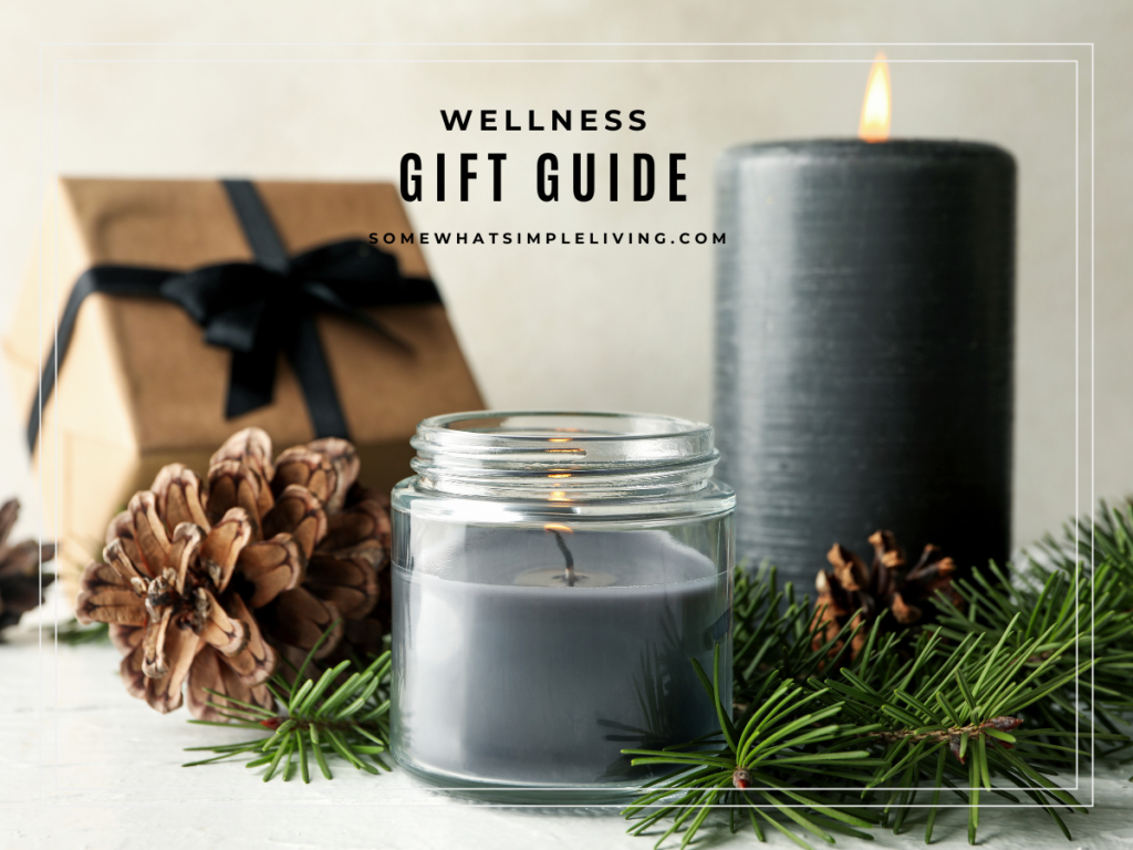 mindfulness and wellness gift guide image showing a wrapped gift next to greenery and 2 candles