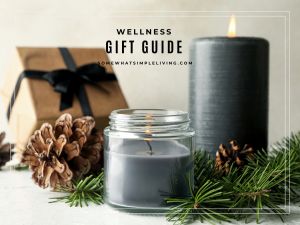 mindfulness and wellness gift guide image showing a wrapped gift next to greenery and 2 candles