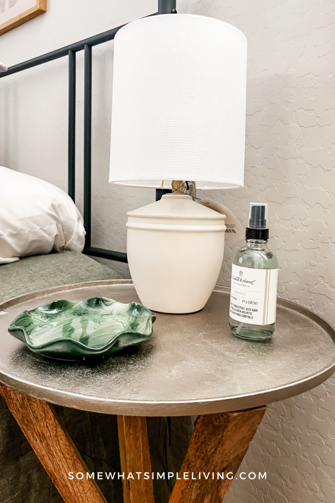 close up of a side table in a guest room with a lamp and valet tray