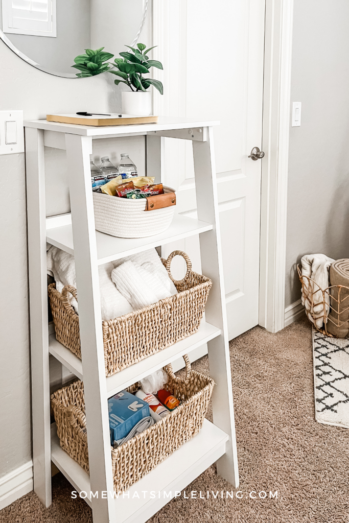 small white shelf with guest room toiletries and linens