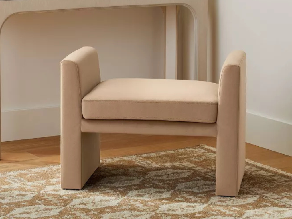 small upholstered bench in a closet